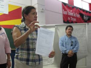 Martha Sanchez holds up a form that members can use to document abuses